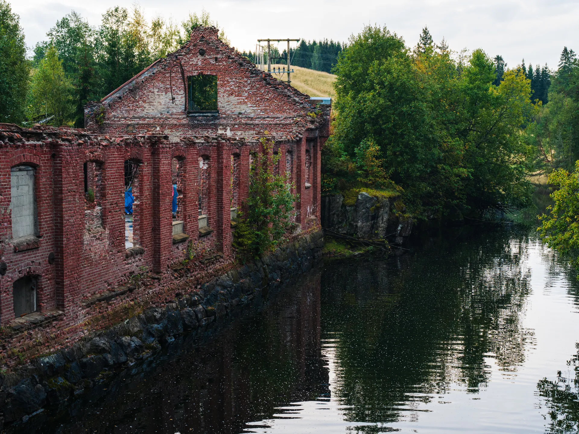 Photograph of abandoned industrial buildings and weathered structures, part of the “Traces of History” collection.