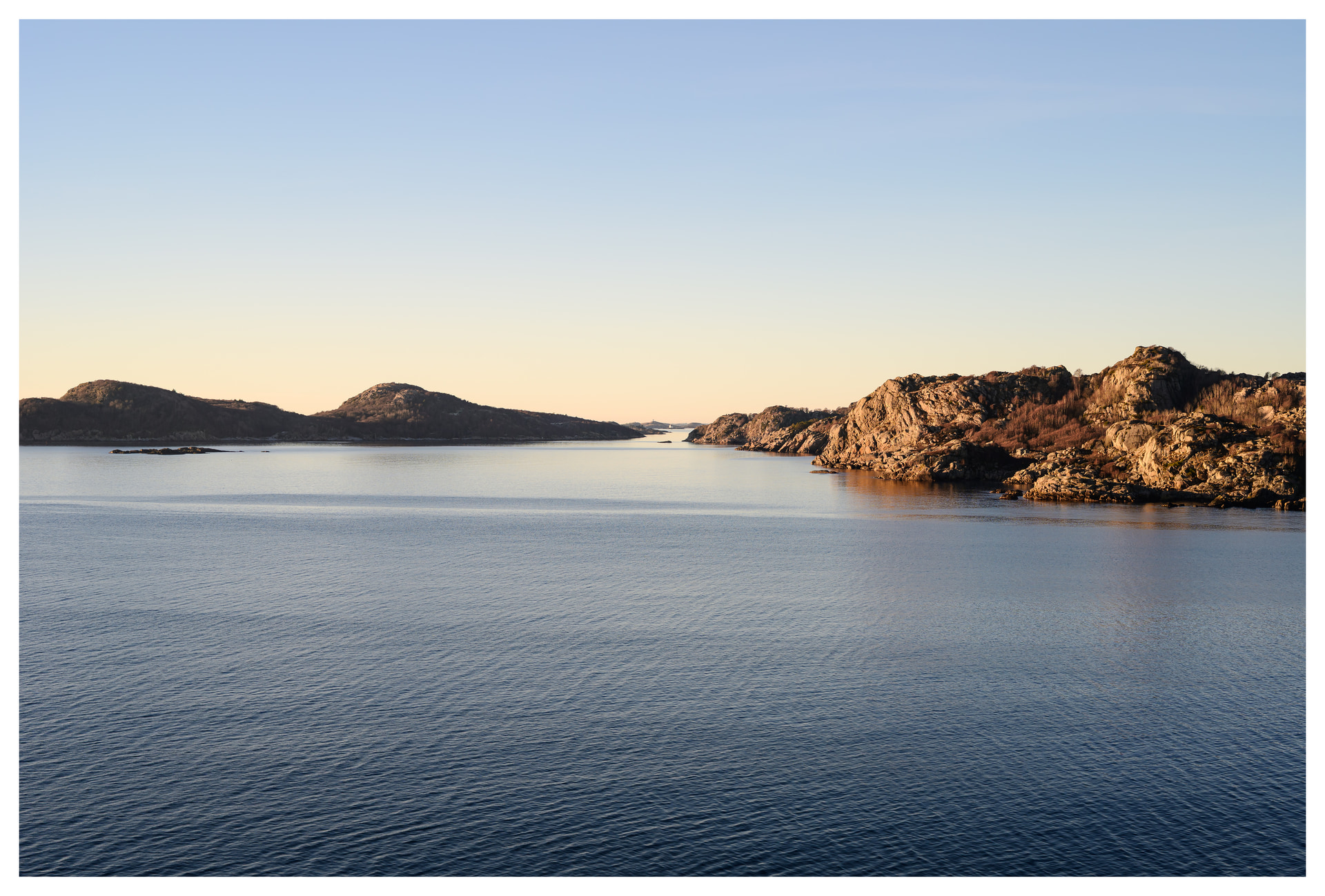 Wide coastal view from the top of Hausvikodden Fort, showing open sea and rocky shoreline.