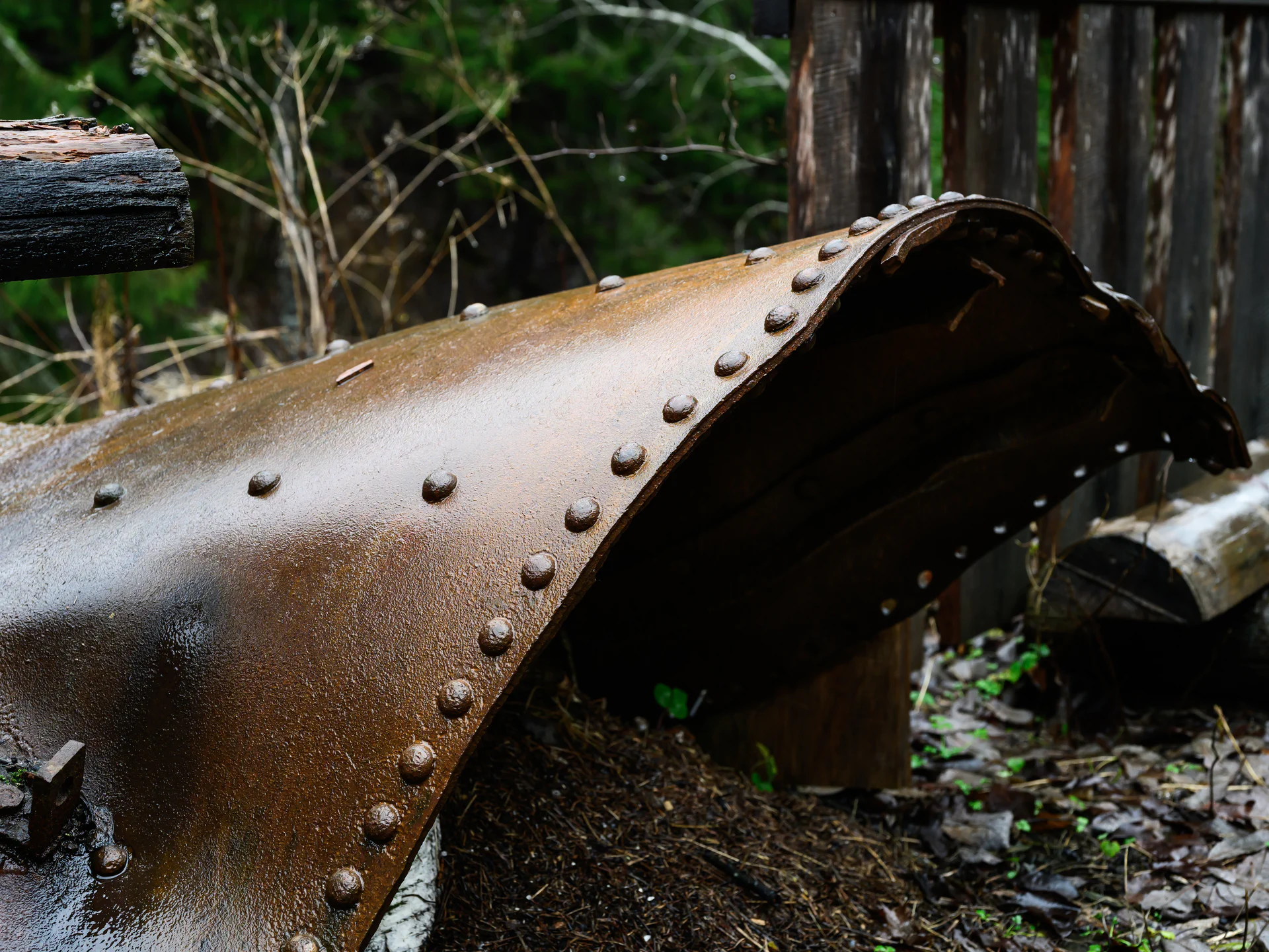 Rust-covered riveted steel from abandoned industrial machinery at the Gunpowder Factory in Nittedal (Kruttverket), Norway, photographed as a detail highlighting decay, texture, and industrial history.