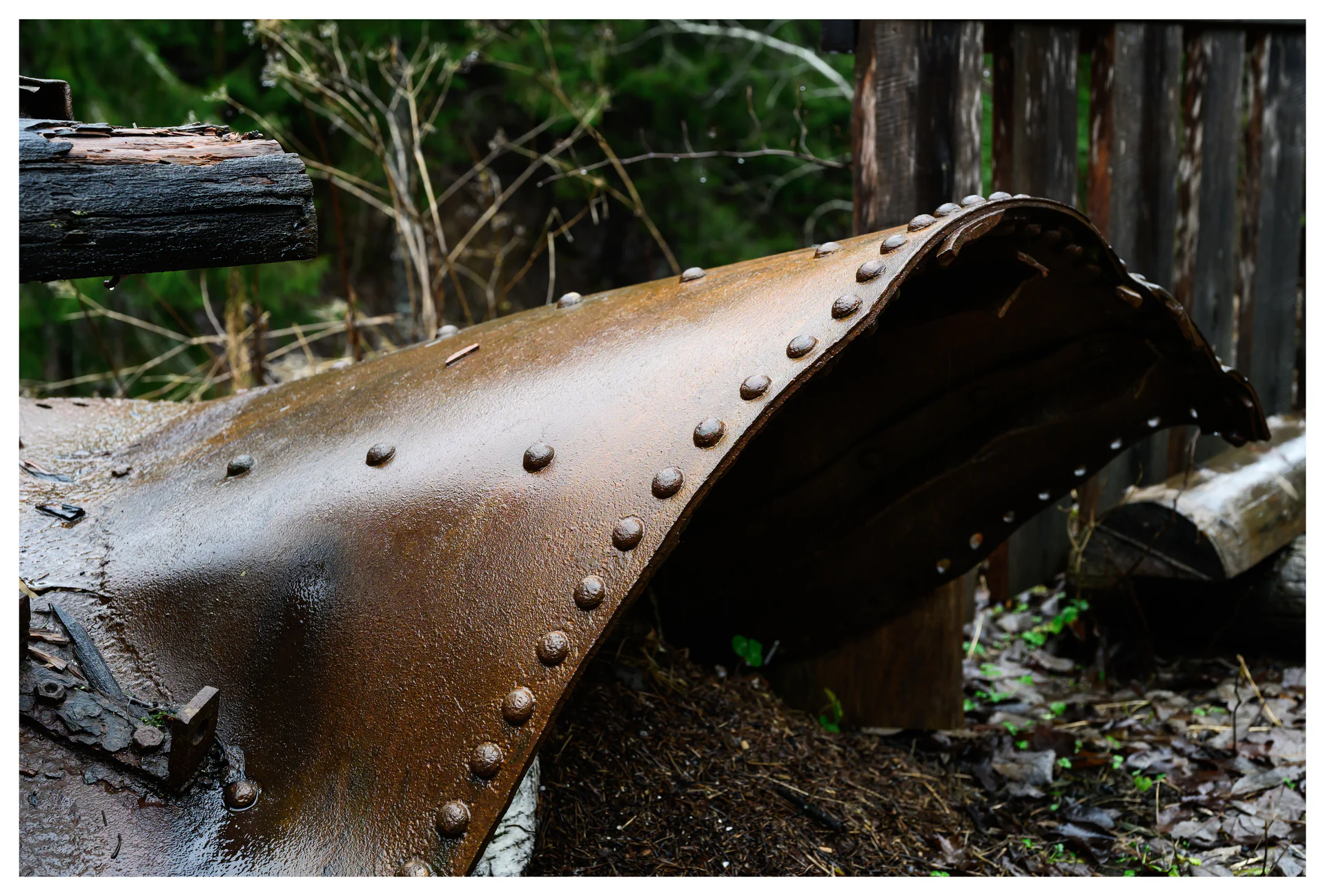 Rust-covered riveted steel from abandoned industrial machinery at the Gunpowder Factory in Nittedal (Kruttverket), Norway, photographed as a detail highlighting decay, texture, and industrial history.