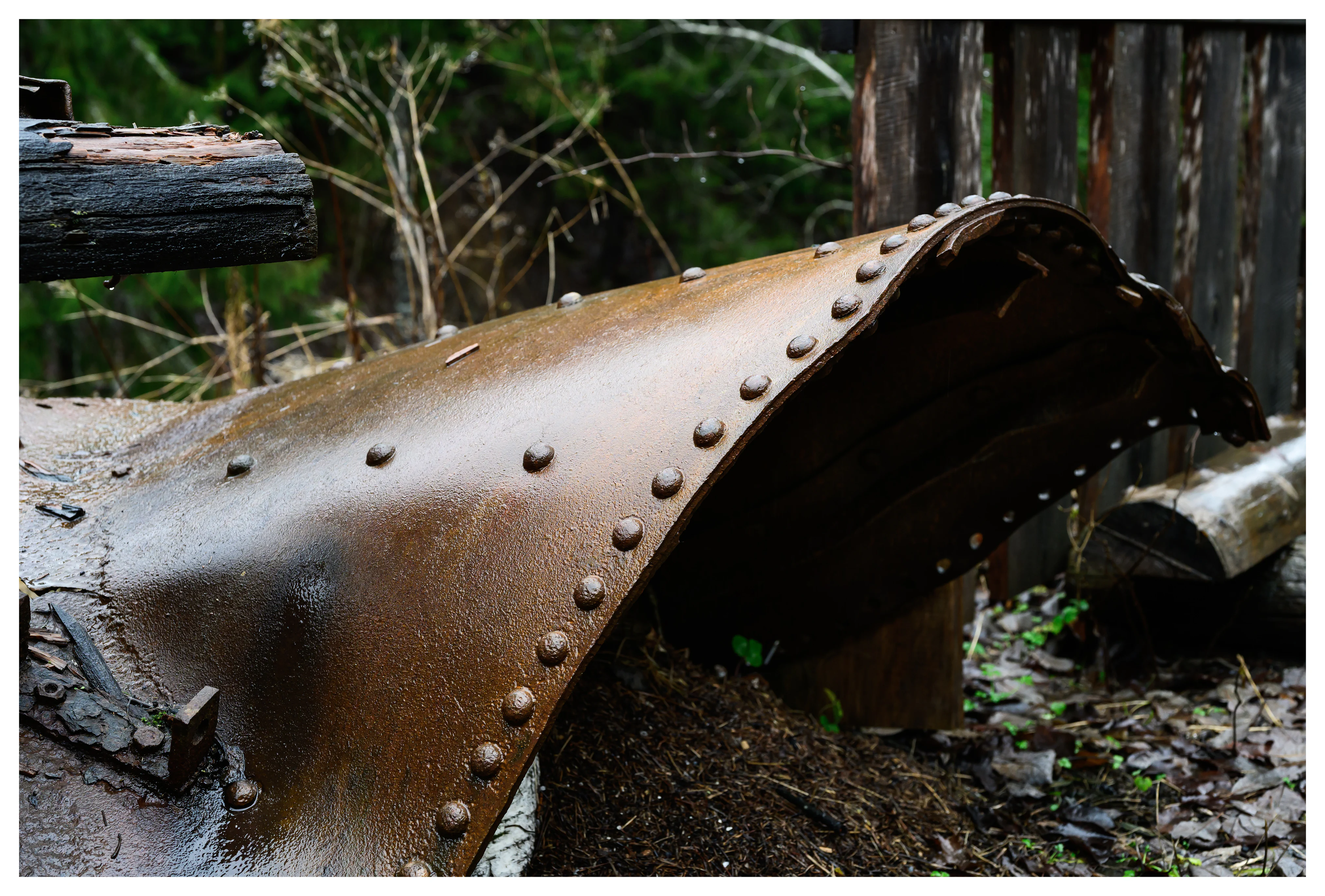 Rust-covered riveted steel from abandoned industrial machinery at the Gunpowder Factory in Nittedal (Kruttverket), Norway, photographed as a detail highlighting decay, texture, and industrial history.