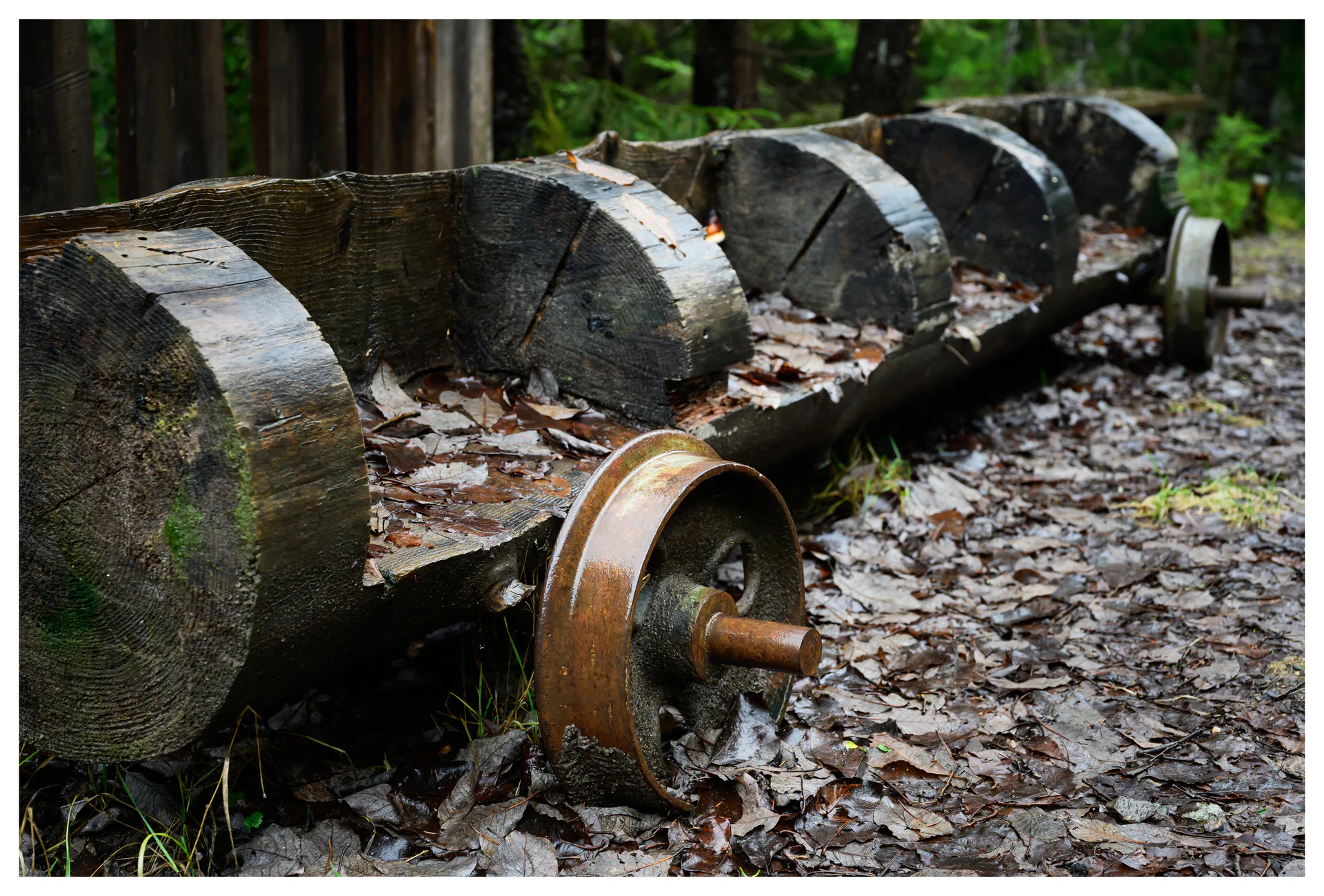 Abandoned industrial machinery with wooden drums and rusted metal wheels at the Gunpowder Factory in Nittedal (Kruttverket), Norway, photographed as a scene showing decay, texture, and industrial heritage.